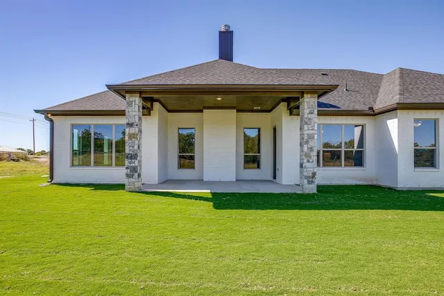 a view of a house with pool and garden