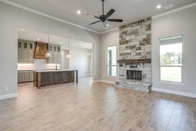 a view of an empty room with a fireplace and a window