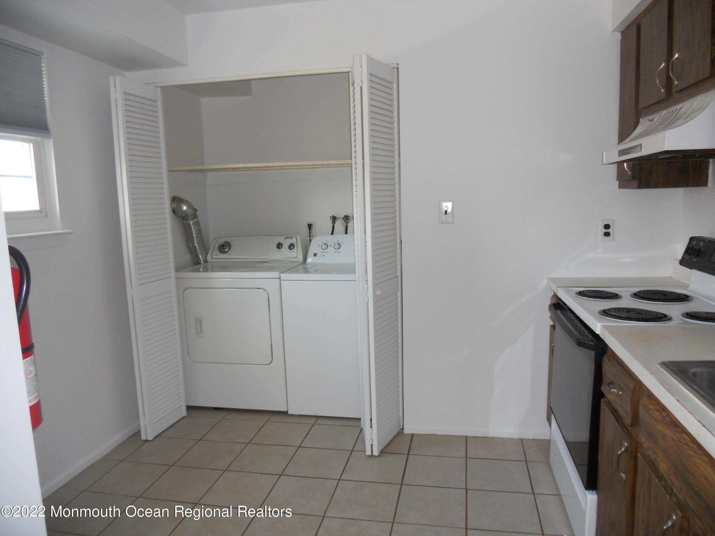228 Sawmill Road Brick, NJ 08724 - Photo 3 of 10 a kitchen with a sink a stove and cabinets