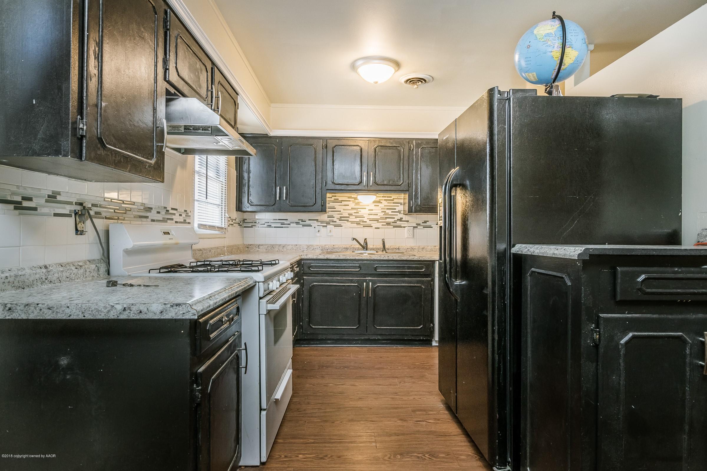 5137 South Bonham Street Amarillo, TX 79110 - Photo 2 of 18 a kitchen with stainless steel appliances granite countertop a sink stove and refrigerator