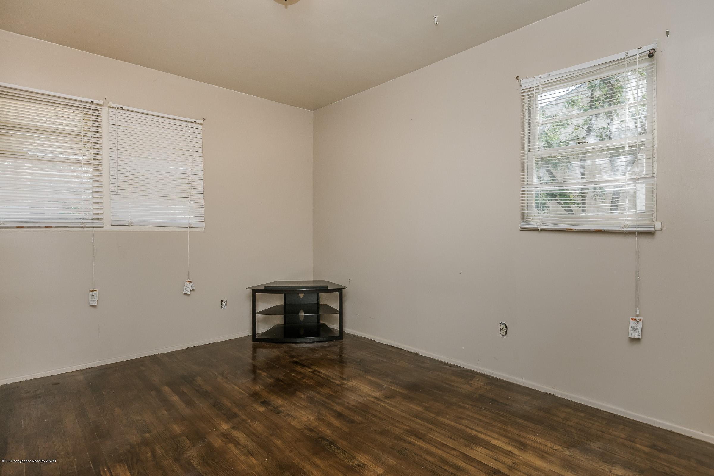 5137 South Bonham Street Amarillo, TX 79110 - Photo 11 of 18 a view of a room with wooden floor and a window