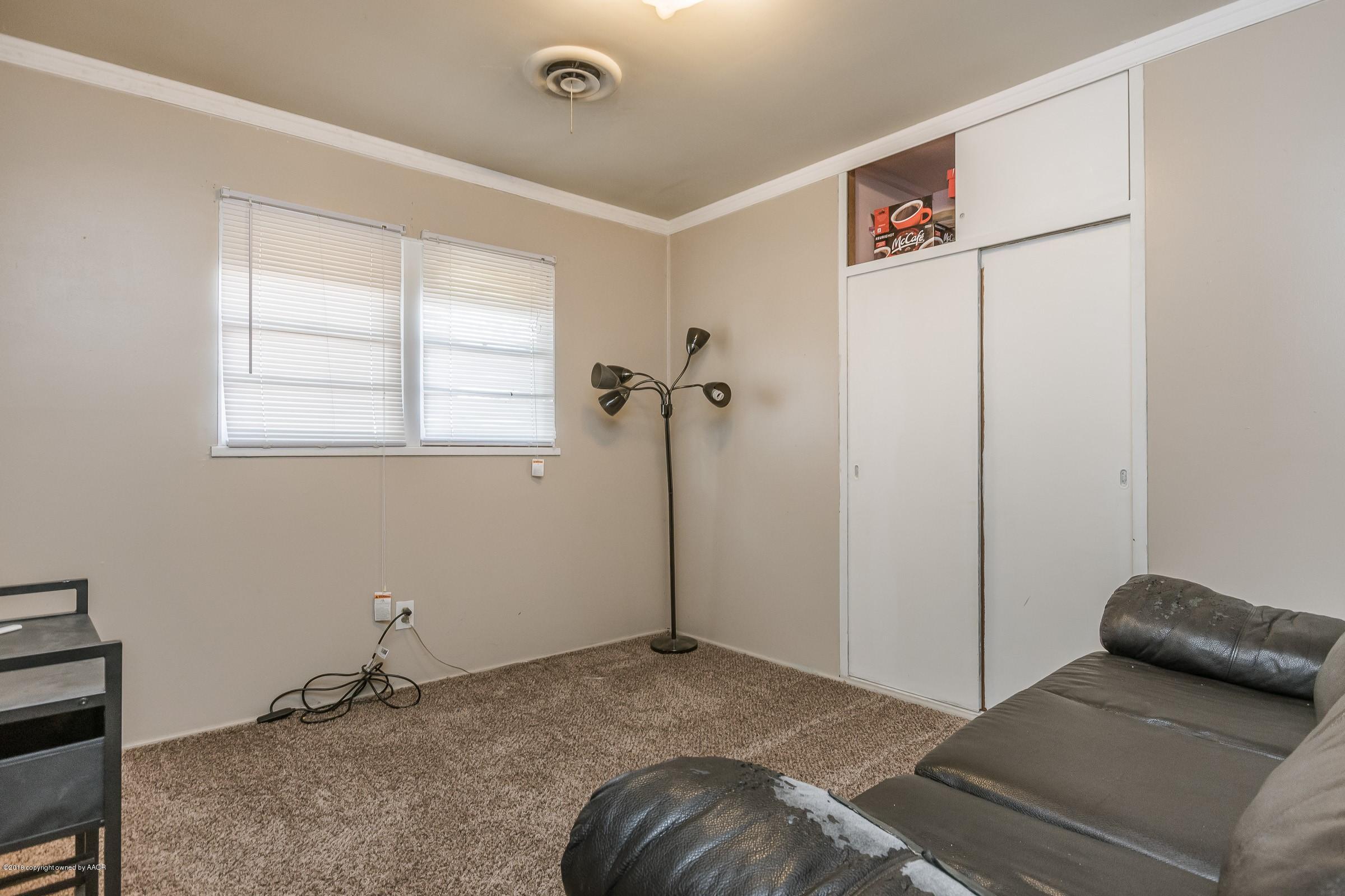 5137 South Bonham Street Amarillo, TX 79110 - Photo 14 of 18 a bedroom with a bed and a window