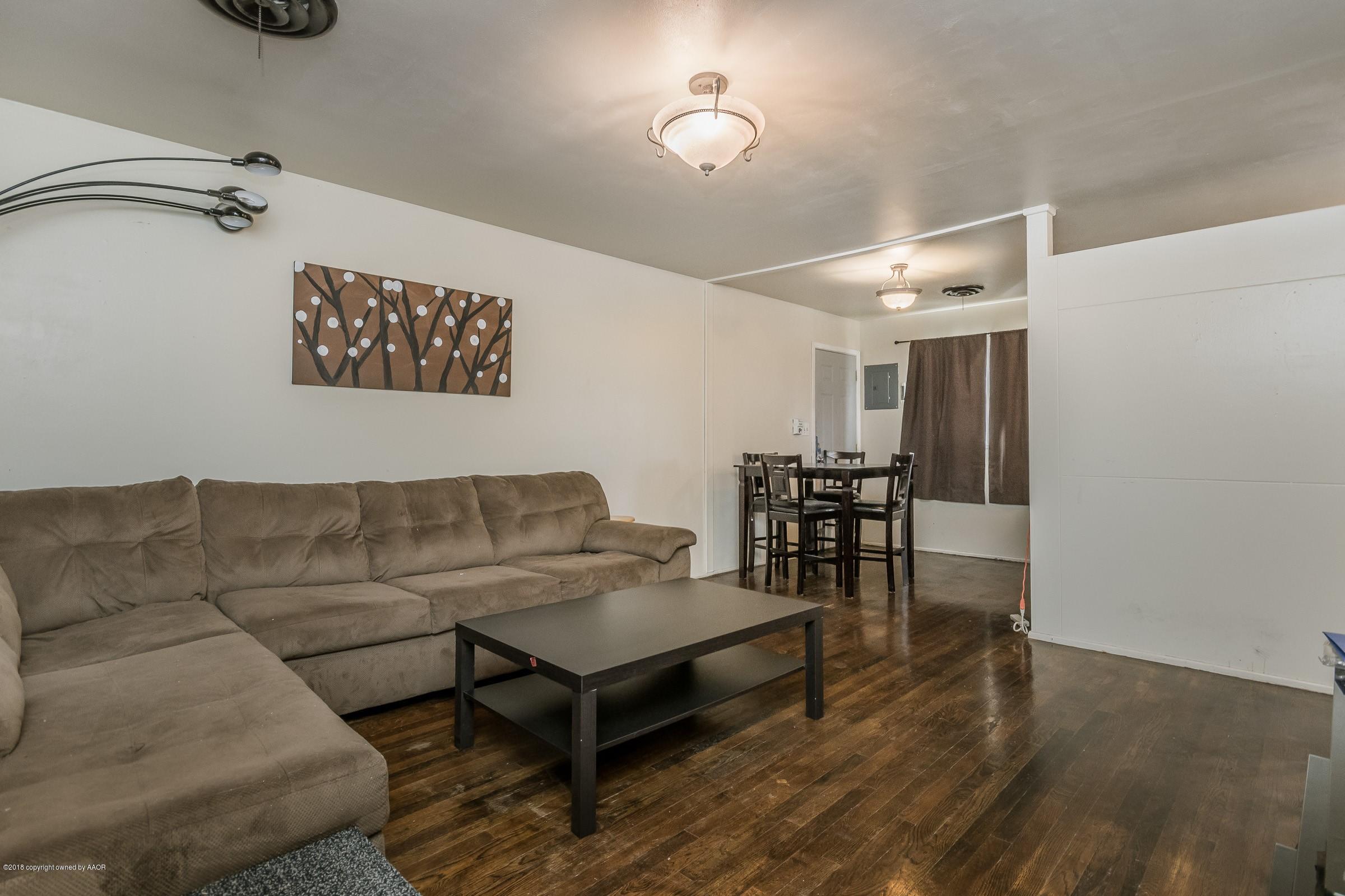 5137 South Bonham Street Amarillo, TX 79110 - Photo 3 of 18 a living room with furniture and a wooden floor