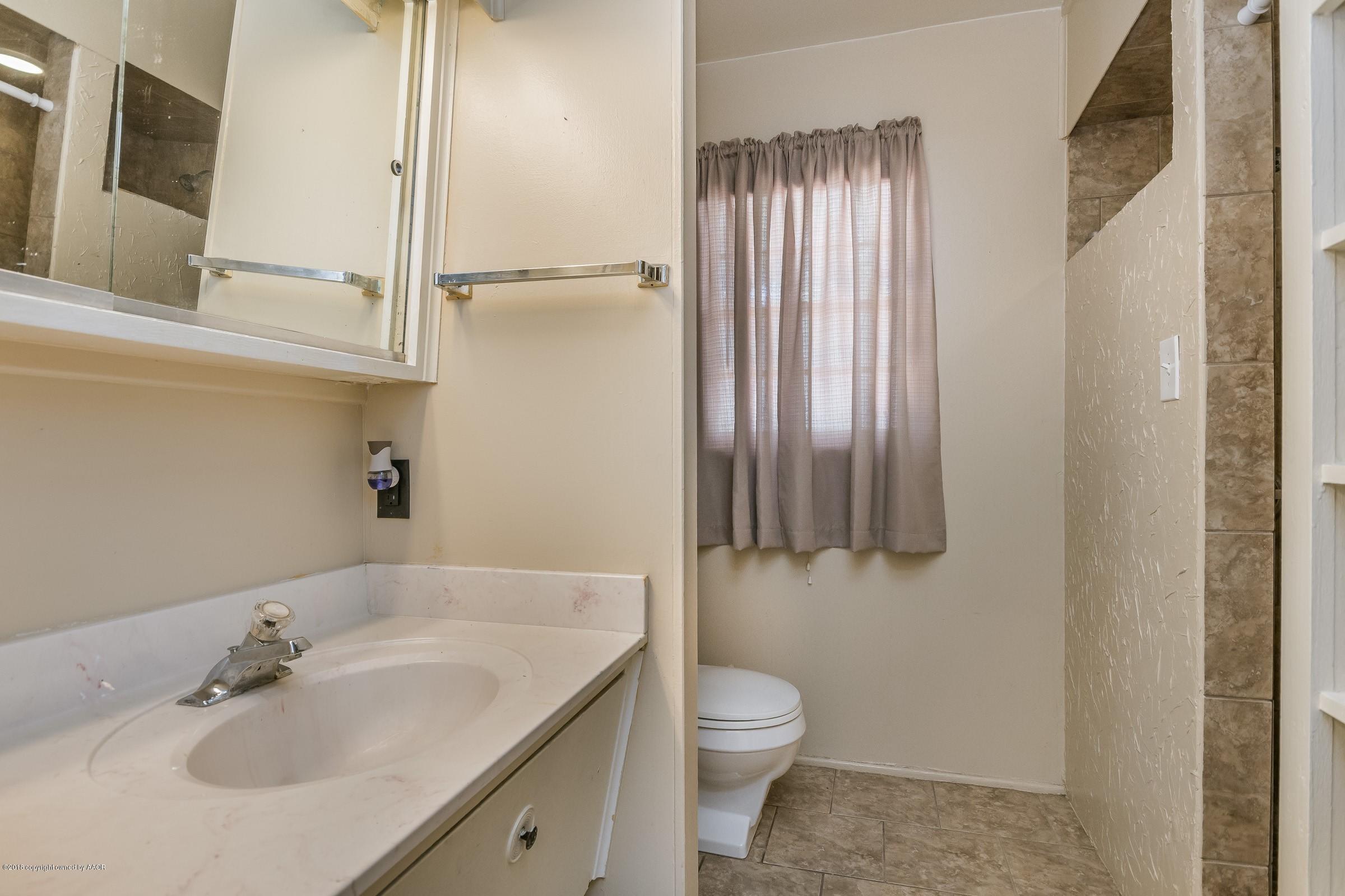 5137 South Bonham Street Amarillo, TX 79110 - Photo 4 of 18 a bathroom with a sink toilet and shower
