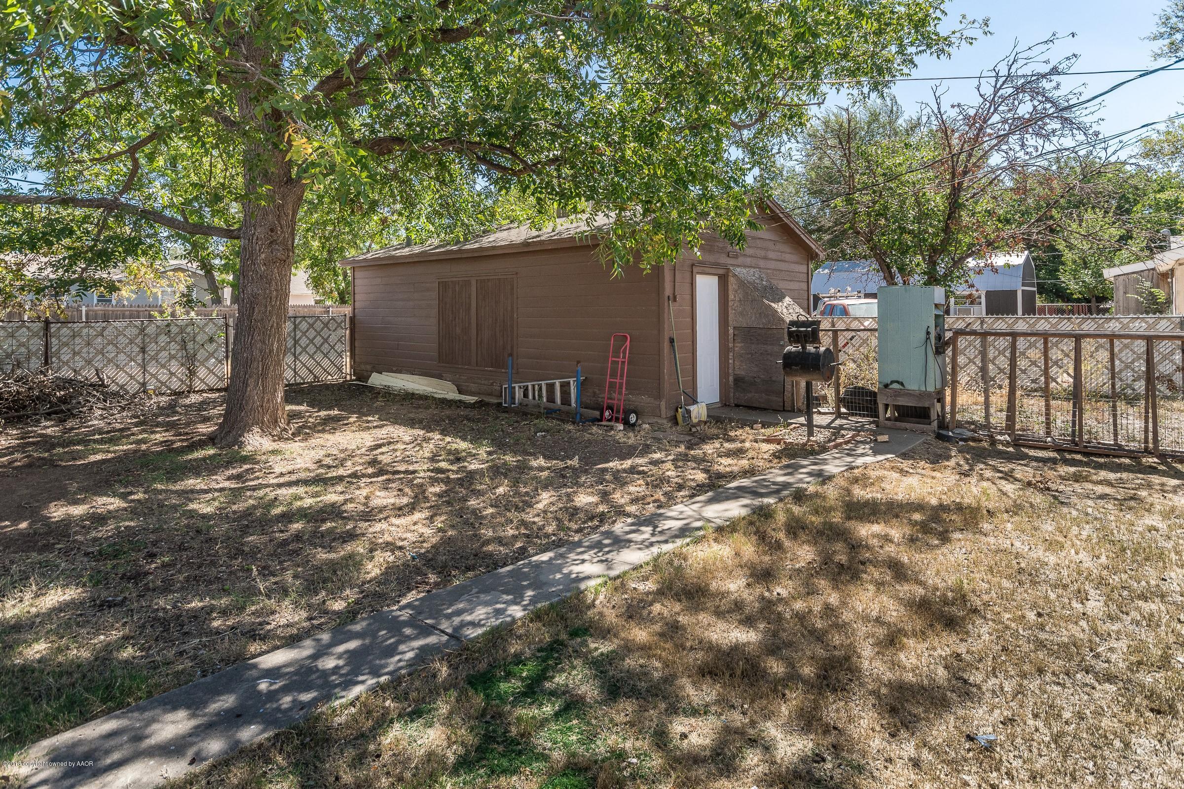 5137 South Bonham Street Amarillo, TX 79110 - Photo 5 of 18 a backyard of a house with lawn chairs and wooden fence