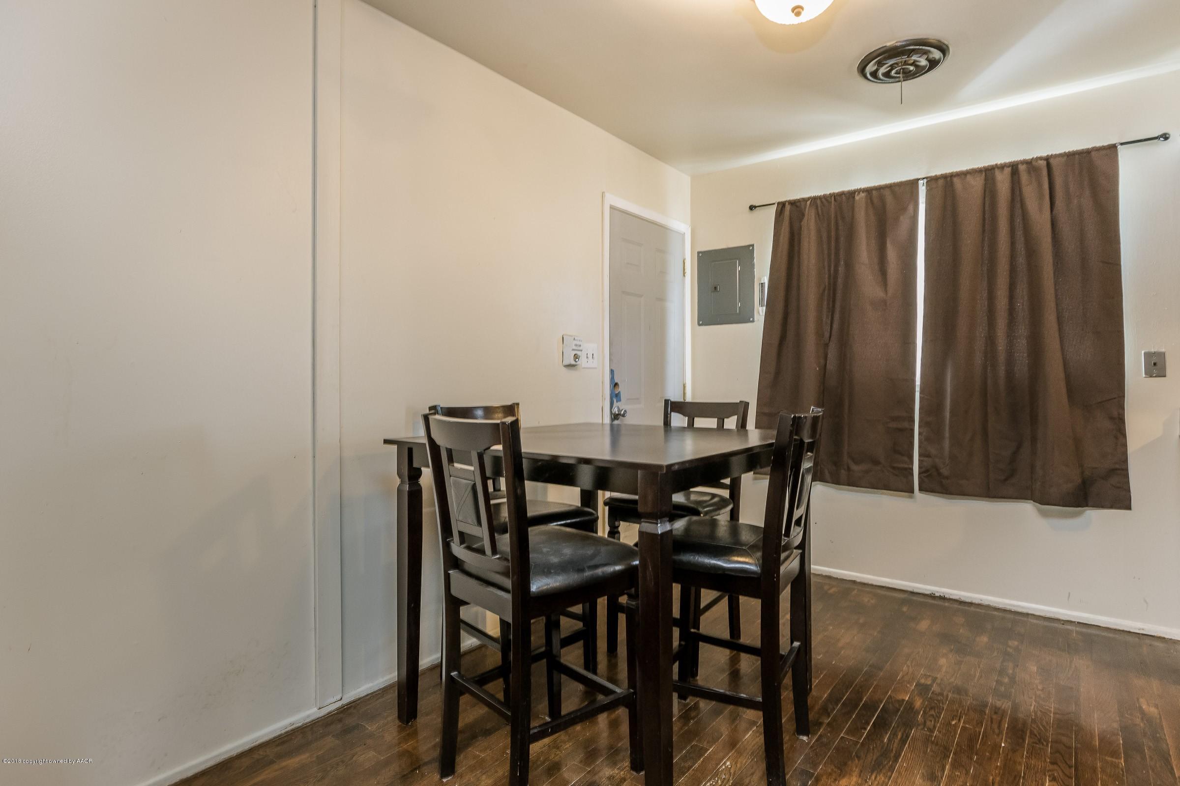 5137 South Bonham Street Amarillo, TX 79110 - Photo 8 of 18 a view of a dining room with furniture and wooden floor