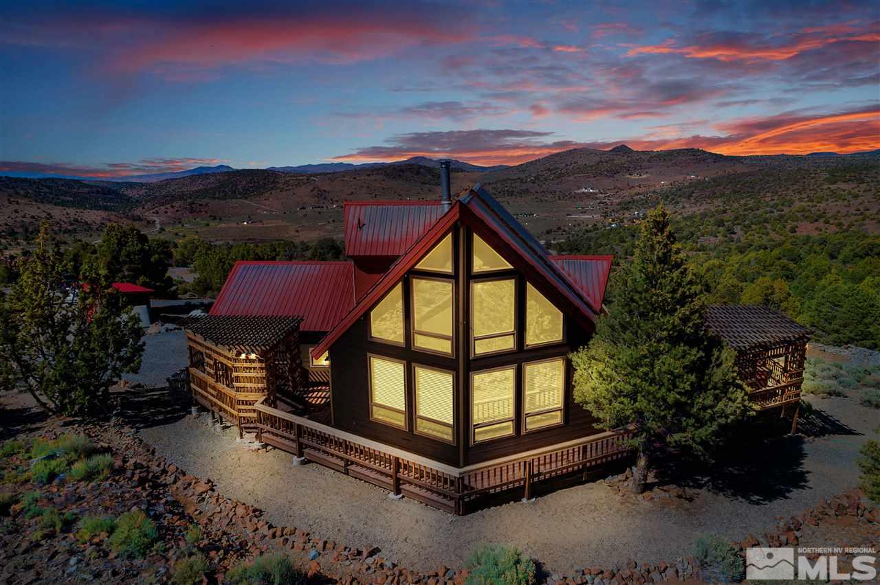 a backyard of a house with wooden fence and a mountain view