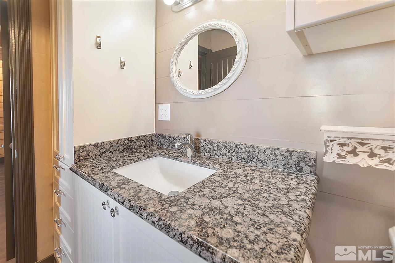 3880 Stovepipe Road Reno, NV 89521 - Photo 13 of 40 a bathroom with a granite countertop sink and a mirror