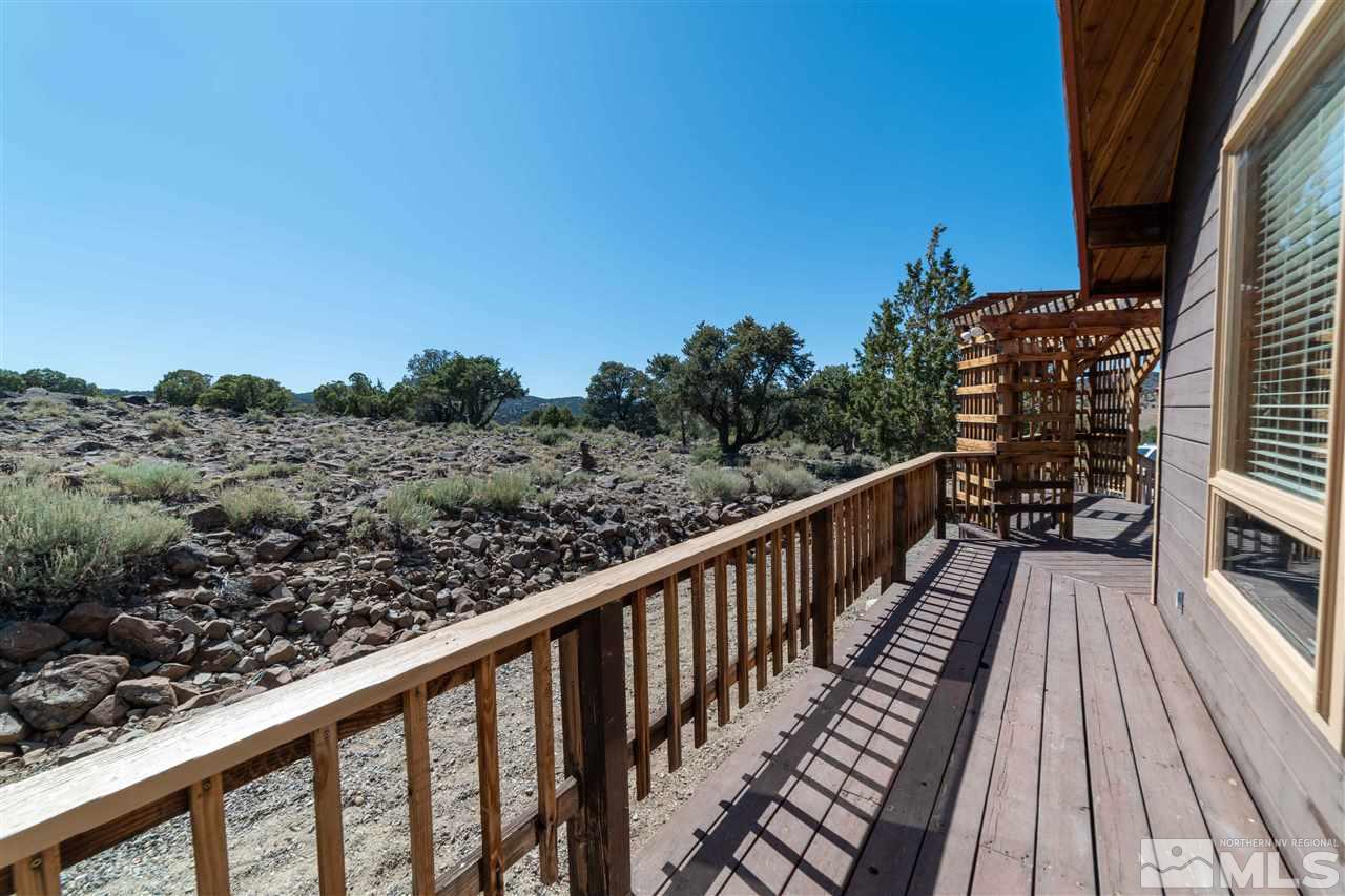 3880 Stovepipe Road Reno, NV 89521 - Photo 32 of 40 a balcony with wooden floor and fence