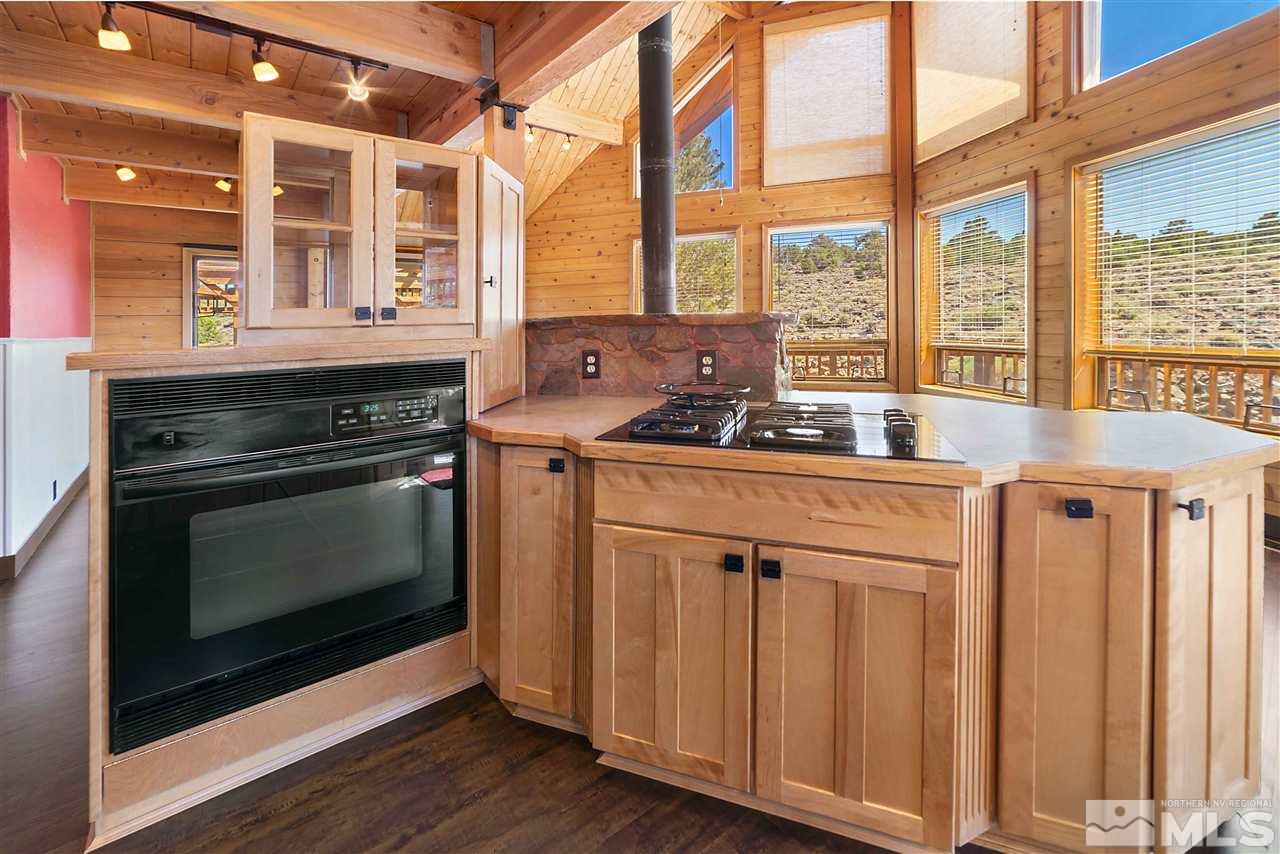 3880 Stovepipe Road Reno, NV 89521 - Photo 6 of 40 a kitchen with stainless steel appliances a stove sink and cabinets