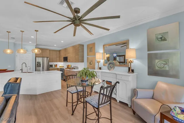 a dining room with furniture and a chandelier