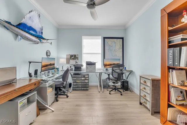 a view of a workspace with furniture and a book shelf