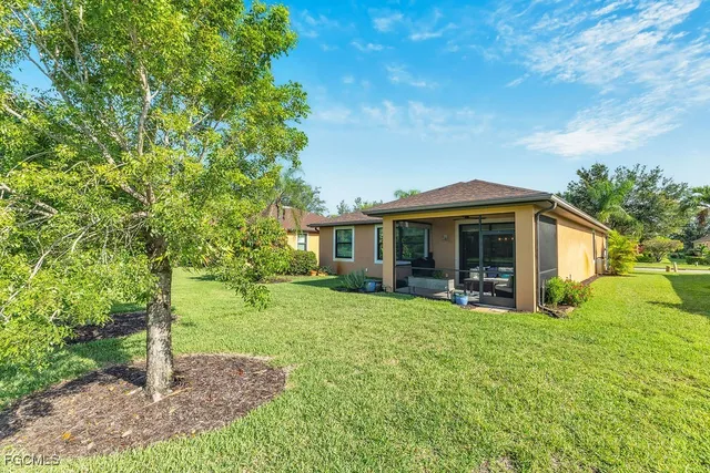 a view of a house with a yard and sitting area