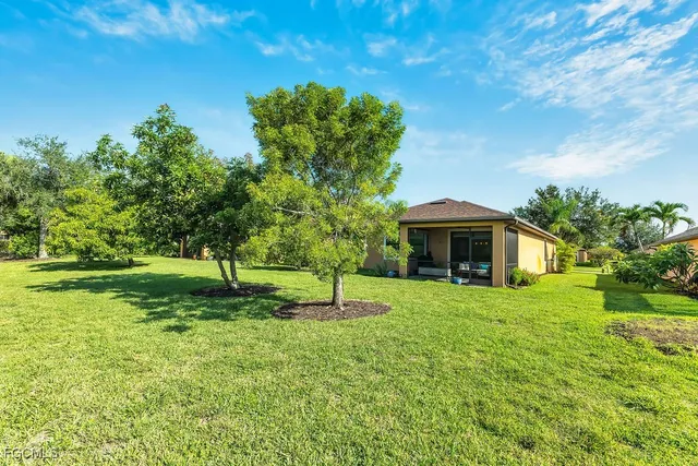 a house with green field in front of it