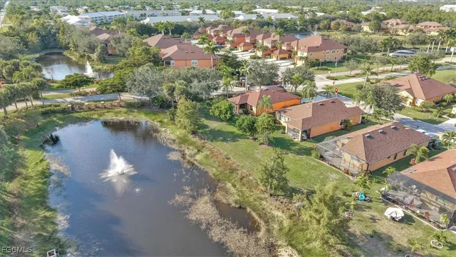 an aerial view of lake residential house with swimming pool and green space