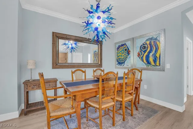 a dining room with furniture and chandelier
