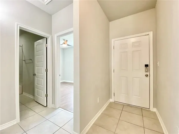 a view of a hallway with wooden floor and closet