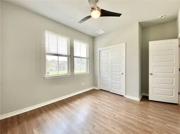 wooden floor in an empty room with a window