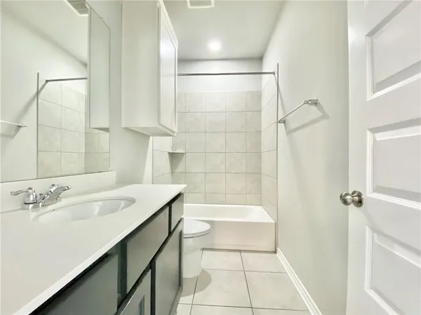 a bathroom with a sink a mirror and a bathtub