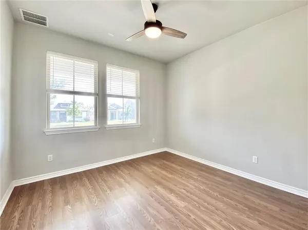wooden floor in an empty room with a window