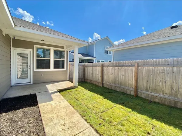 a view of a house with a backyard
