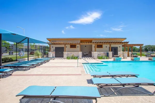 a view of a patio with couches and table and chairs under an umbrella
