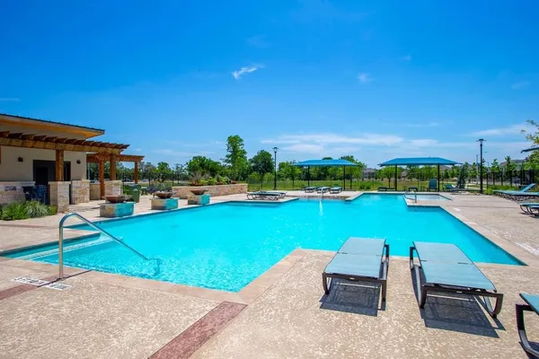 a view of swimming pool with outdoor seating and yard