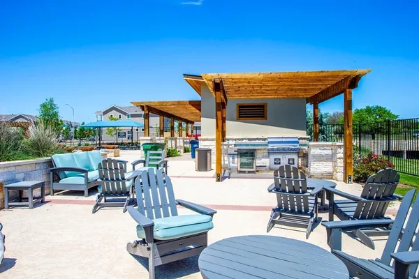 a view of a patio with couches table and chairs with potted plants