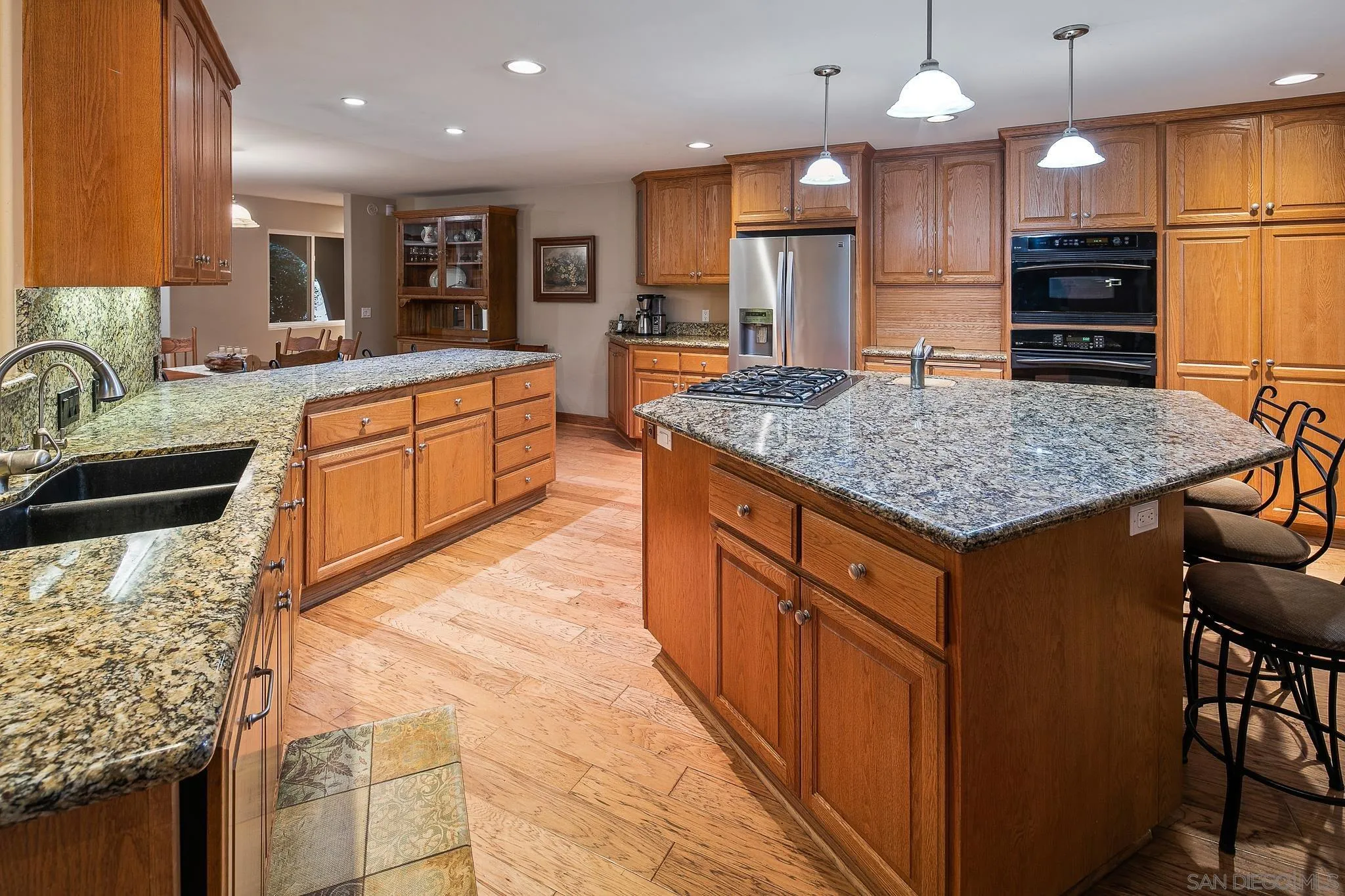 1528 South Grade Road Alpine, CA 91901 - Photo 23 of 65 a kitchen with stainless steel appliances kitchen island granite countertop a sink counter space and cabinets