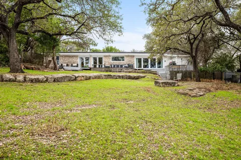 a view of a house with swimming pool and sitting area