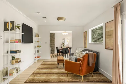 a living room with fireplace furniture and flat screen tv