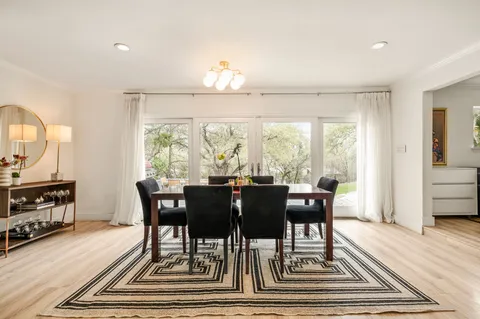 a view of a dining room with furniture window and wooden floor
