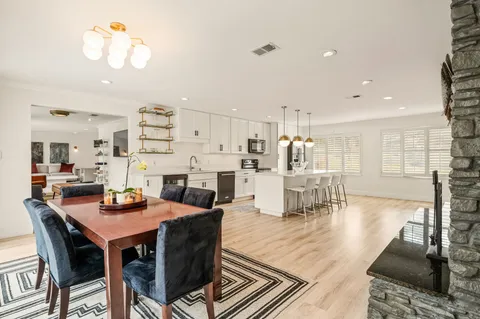 a dining room with furniture and wooden floor