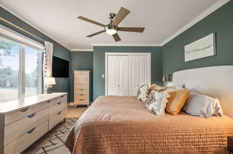 a bedroom with a large bed and a large window