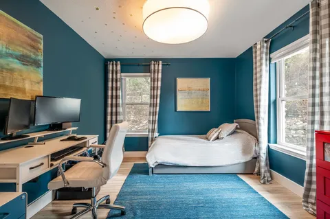 a bedroom with bed and a flat screen tv