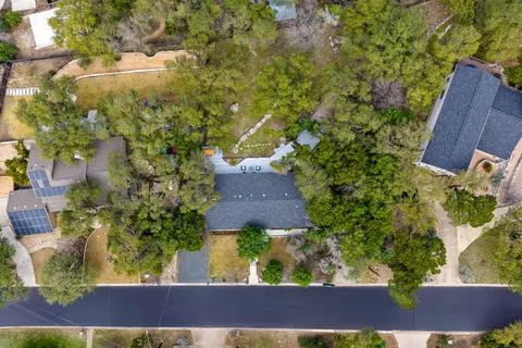 an aerial view of a house with a yard basket ball court and outdoor seating