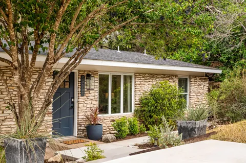 a front view of a house with garden