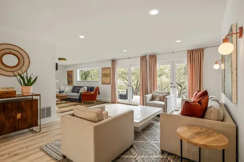 a living room with furniture and a large window