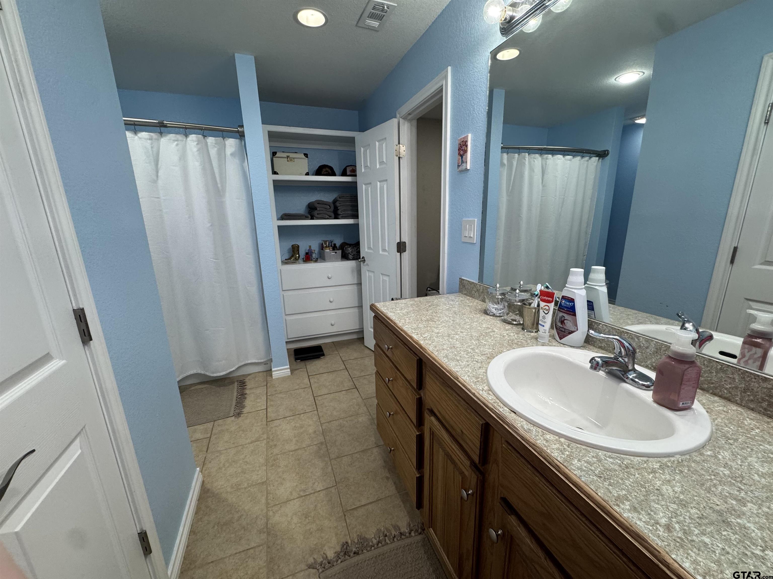 508 County Road 2147 Troup, TX 75789 - Photo 14 of 24 a bathroom with a sink and a mirror