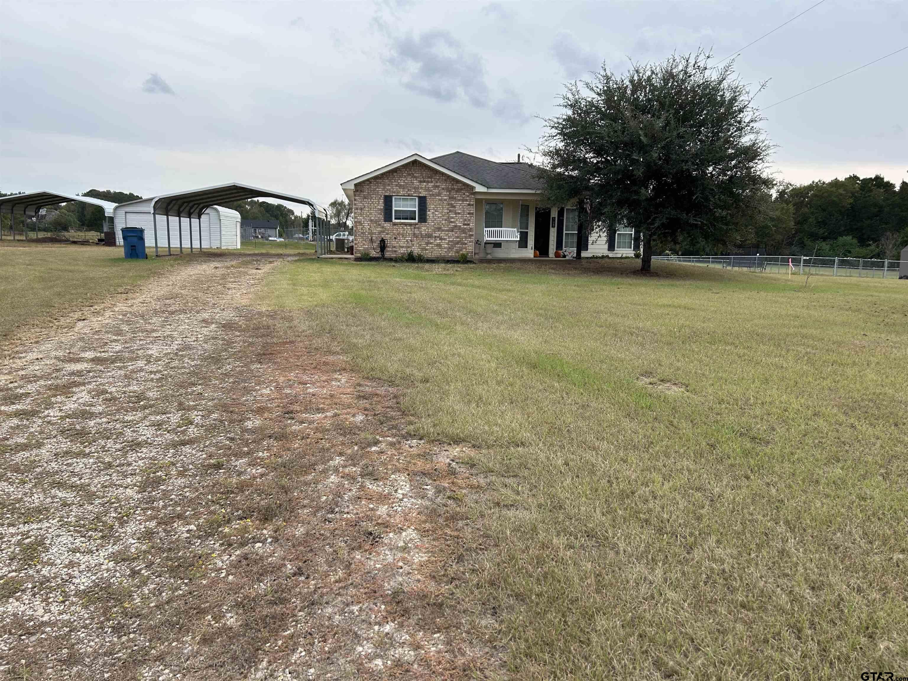 508 County Road 2147 Troup, TX 75789 - Photo 2 of 24 a view of a house with a big yard and large trees