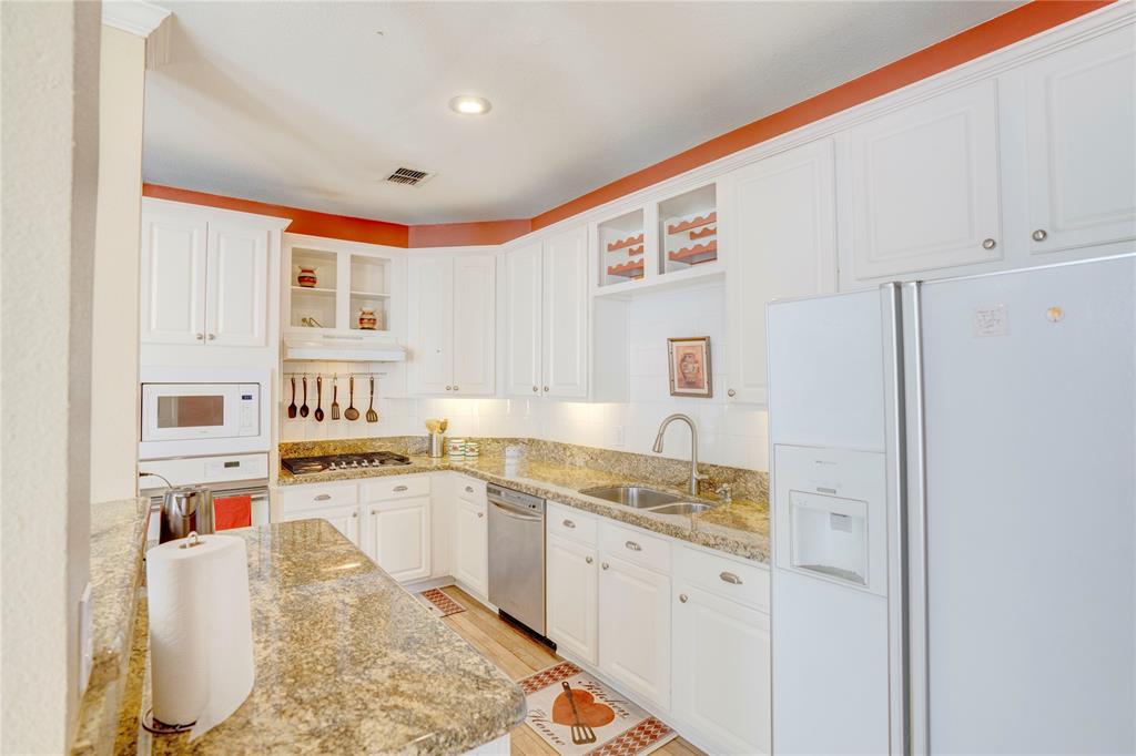 9504 Rodeo Drive Irving, TX 75063 - Photo 12 of 35 a kitchen with stainless steel appliances granite countertop a refrigerator sink and white cabinets