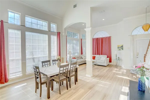 a view of a dining room with furniture and a large window