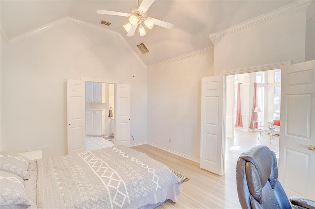 9504 Rodeo Drive Irving, TX 75063 - Photo 17 of 35 a bedroom with a bed and a chandelier