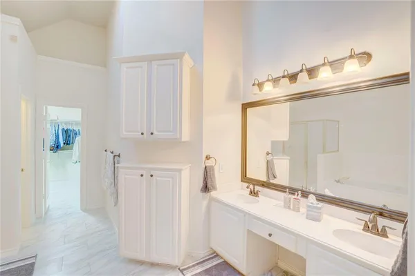 a bathroom with double vanity sink and a mirror