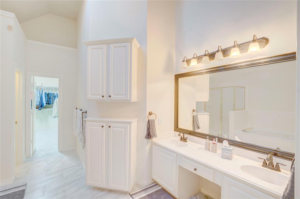 9504 Rodeo Drive Irving, TX 75063 - Photo 18 of 35 a bathroom with double vanity sink and a mirror