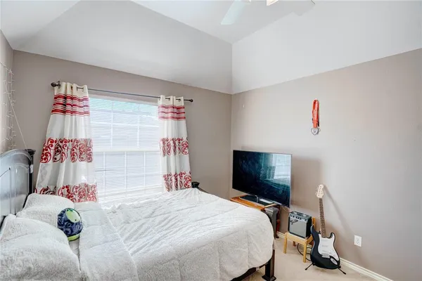 a bed room with a bed and a chair