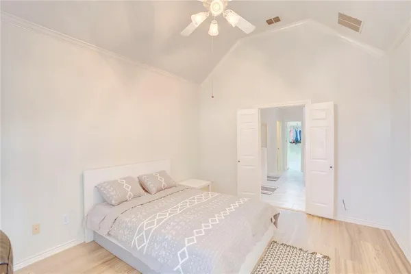a bedroom with a bed and a mirror