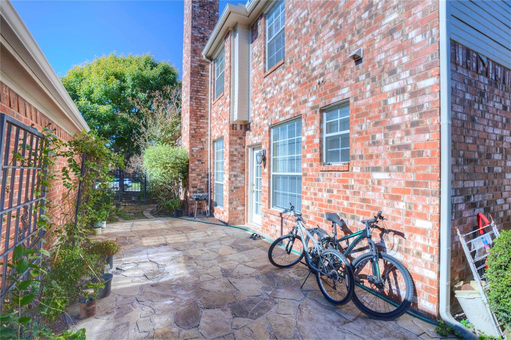 9504 Rodeo Drive Irving, TX 75063 - Photo 32 of 35 a view of a brick wall with a table and chairs in patio