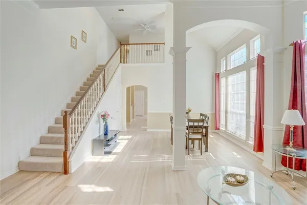 a view of entryway and hall with wooden floor