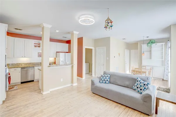 a living room with furniture and kitchen view